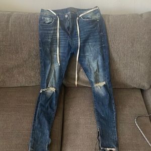 Blue washed YoungLA distressed jeans with zippered ankles. Size 32/30